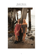 Two friends posing under a pier at sunset, portrait photography