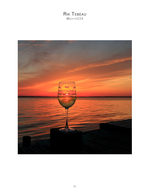 Wine glass silhouetted against a dock sunset, still life photography