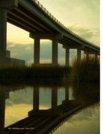landscape photography of a bridge reflected at dusk