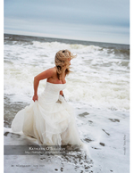 portrait photography of a bride running through the surf