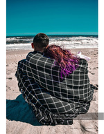 Couple portrait photography wrapped in a blanket on the beach