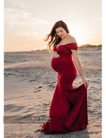 Maternity portrait photography in a red gown at sunset