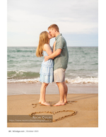 Couple portrait photography with a heart drawn in the sand