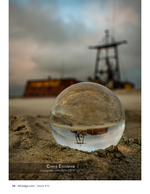 Old rig reflected in a glass sphere, still life photography